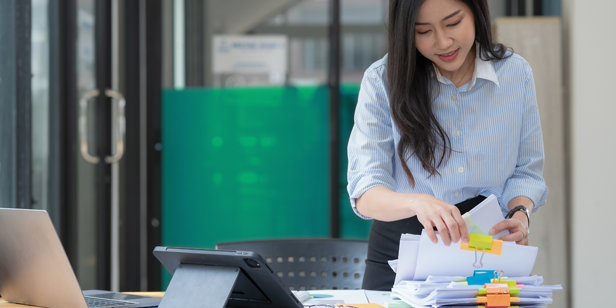 woman sorting through paperwork in an office